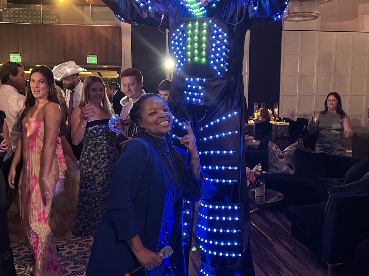 After Party vocalist with an LED stilt performer at a corporate gala